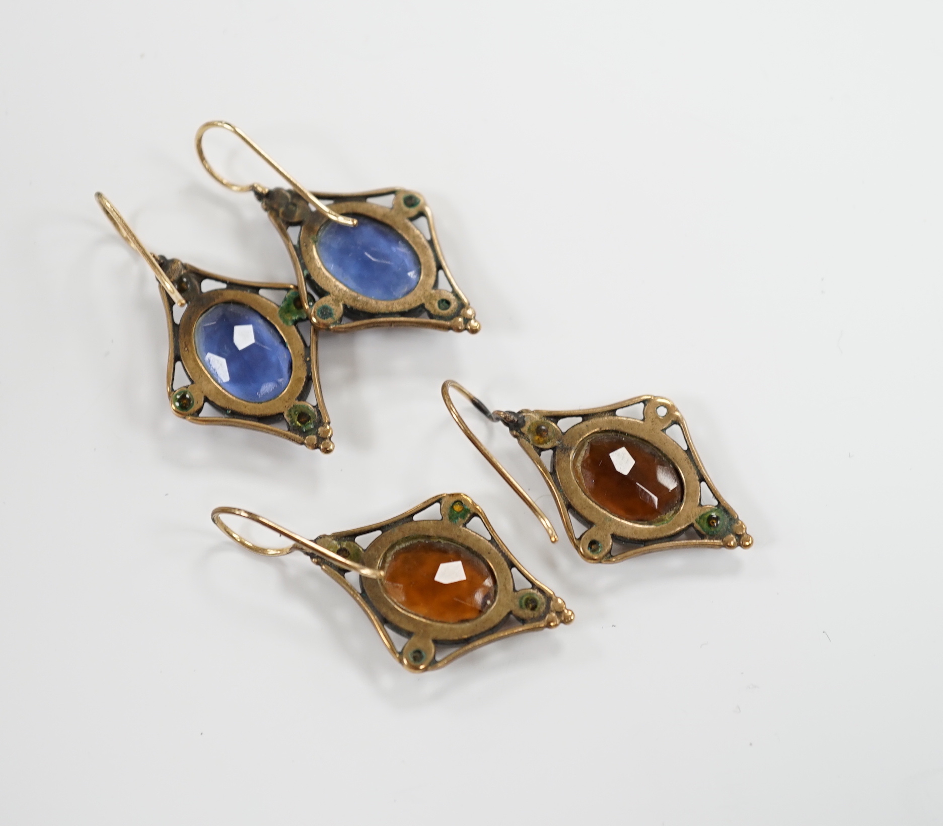 Two pairs of early 20th century gilt metal and coloured paste set drop earrings, overall 37mm.